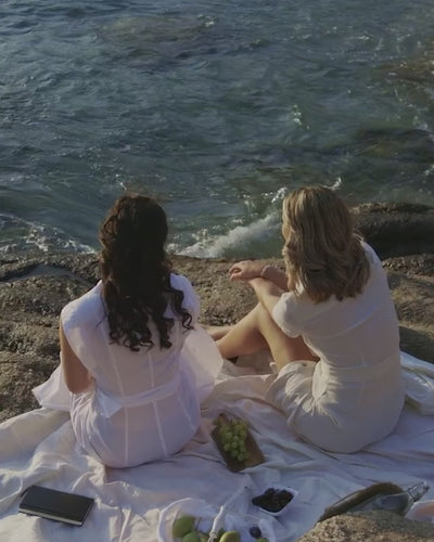 Models enjoying picnic in greece in Cassandra Goad jewels 