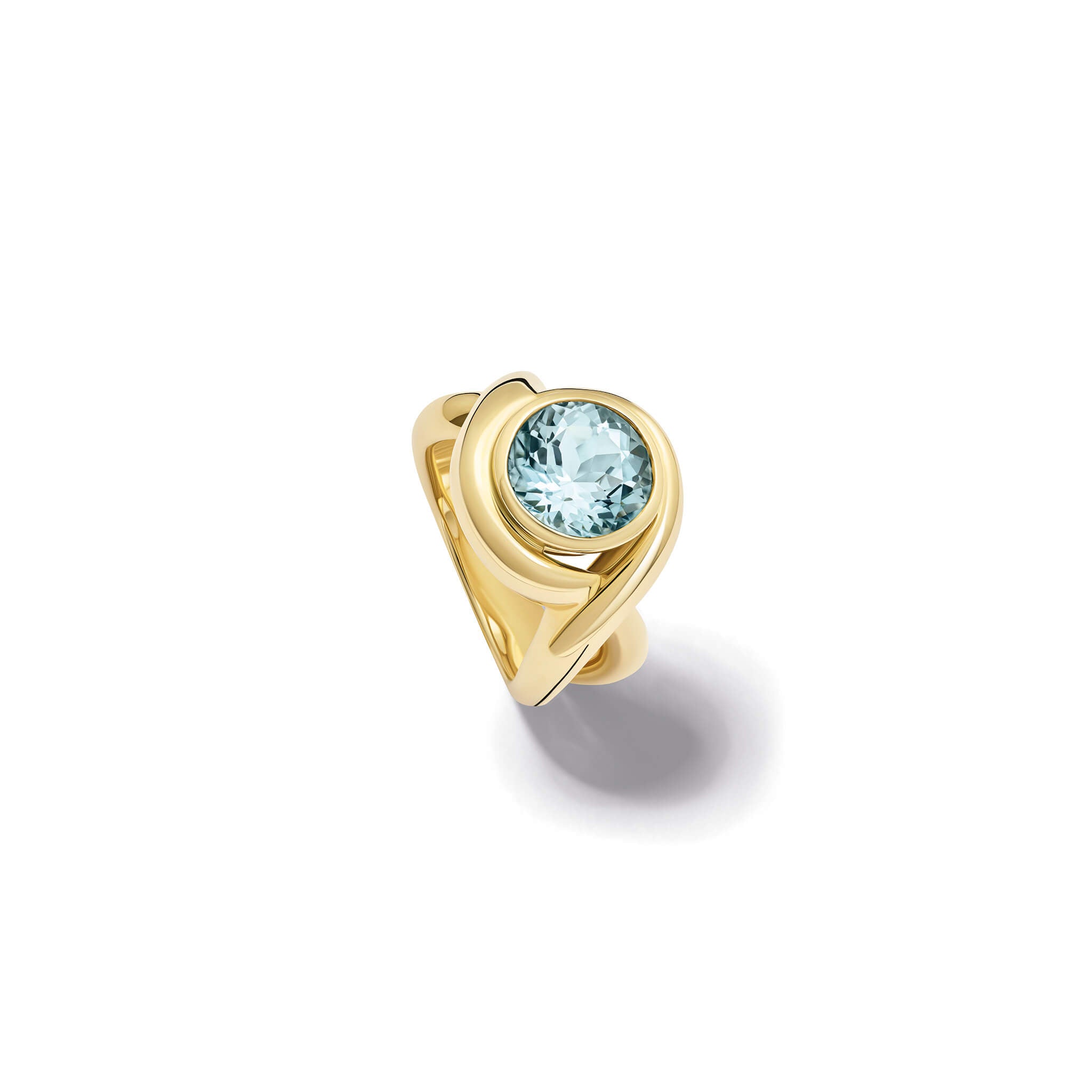 Handcrafted yellow gold ring featuring curved shanks with a round blue topaz, birthstone of November.