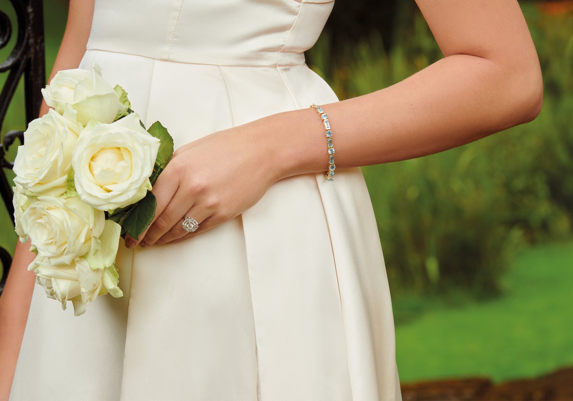 Model wearing handcrafted white gold jewellery featuring blue precious gemstones for a bride, something blue gifting