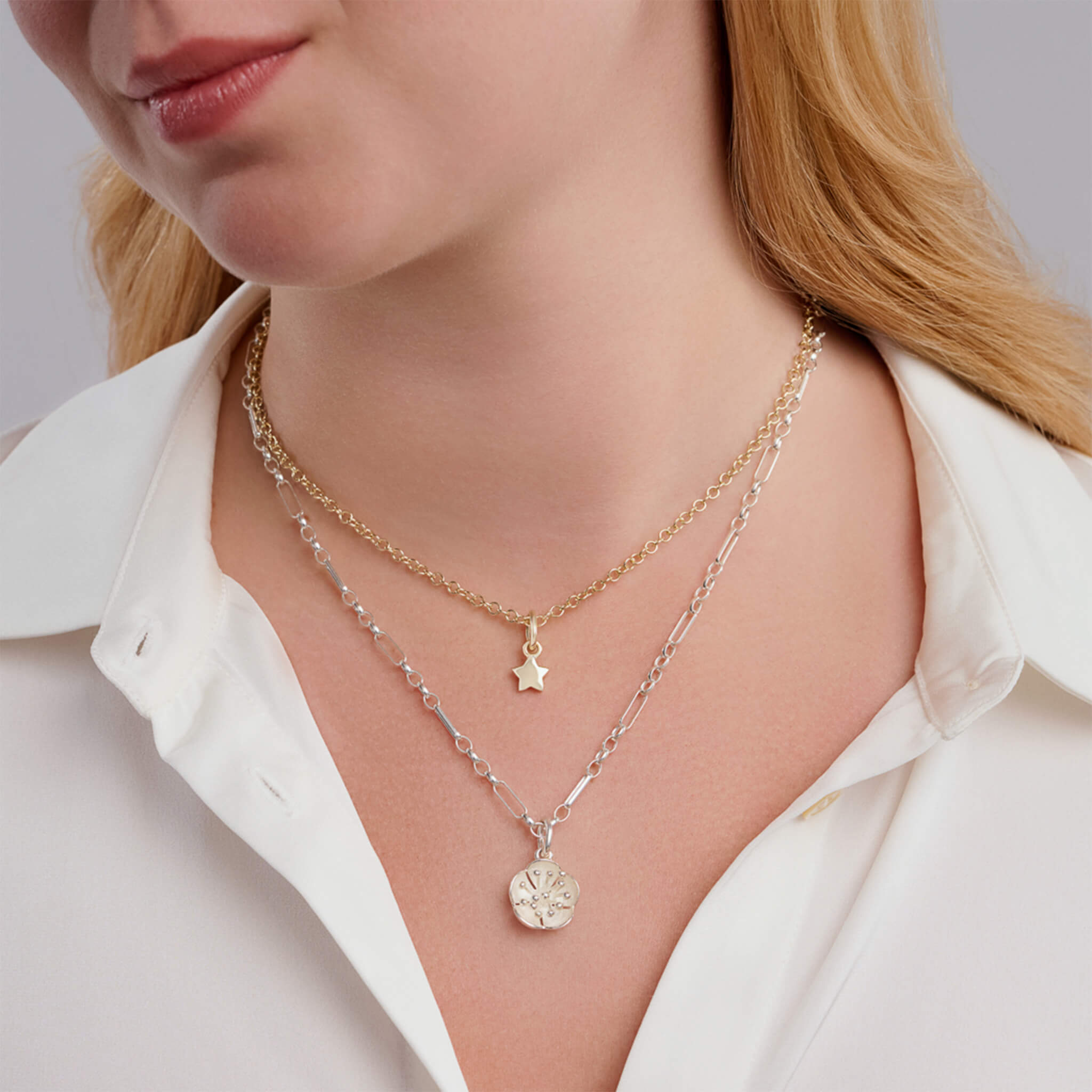Model wearing star pendant and plum blossom pendant.