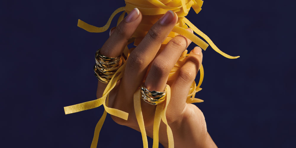 Model wearing Cassandra Goad Tagliatelle rings holding ribbon pasta