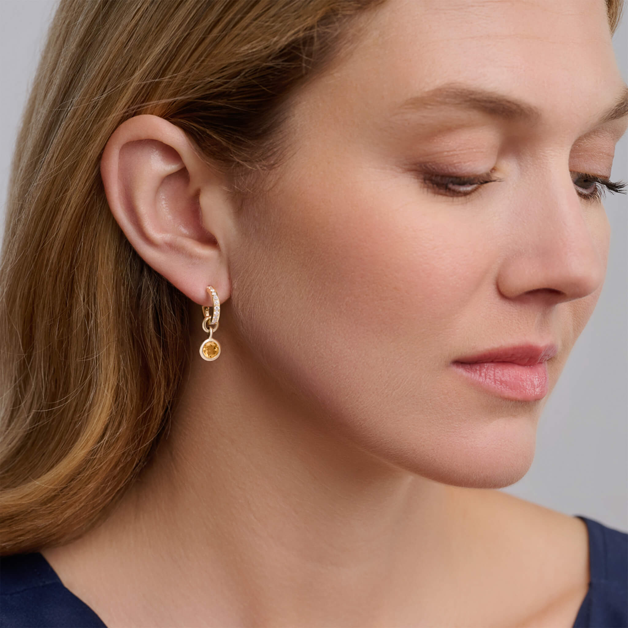 Handcrafted round yellow gold earring drops with citrine, birthstone of November.