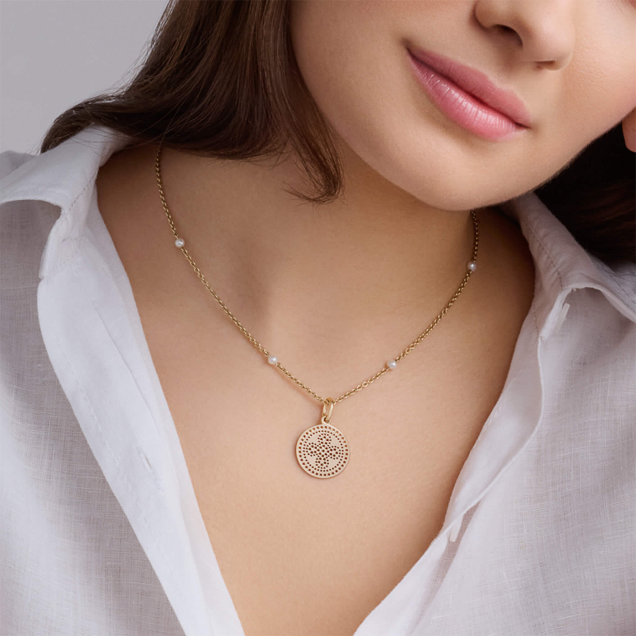 Handcrafted yellow gold necklace pendant featuring a pierced cross pattern.