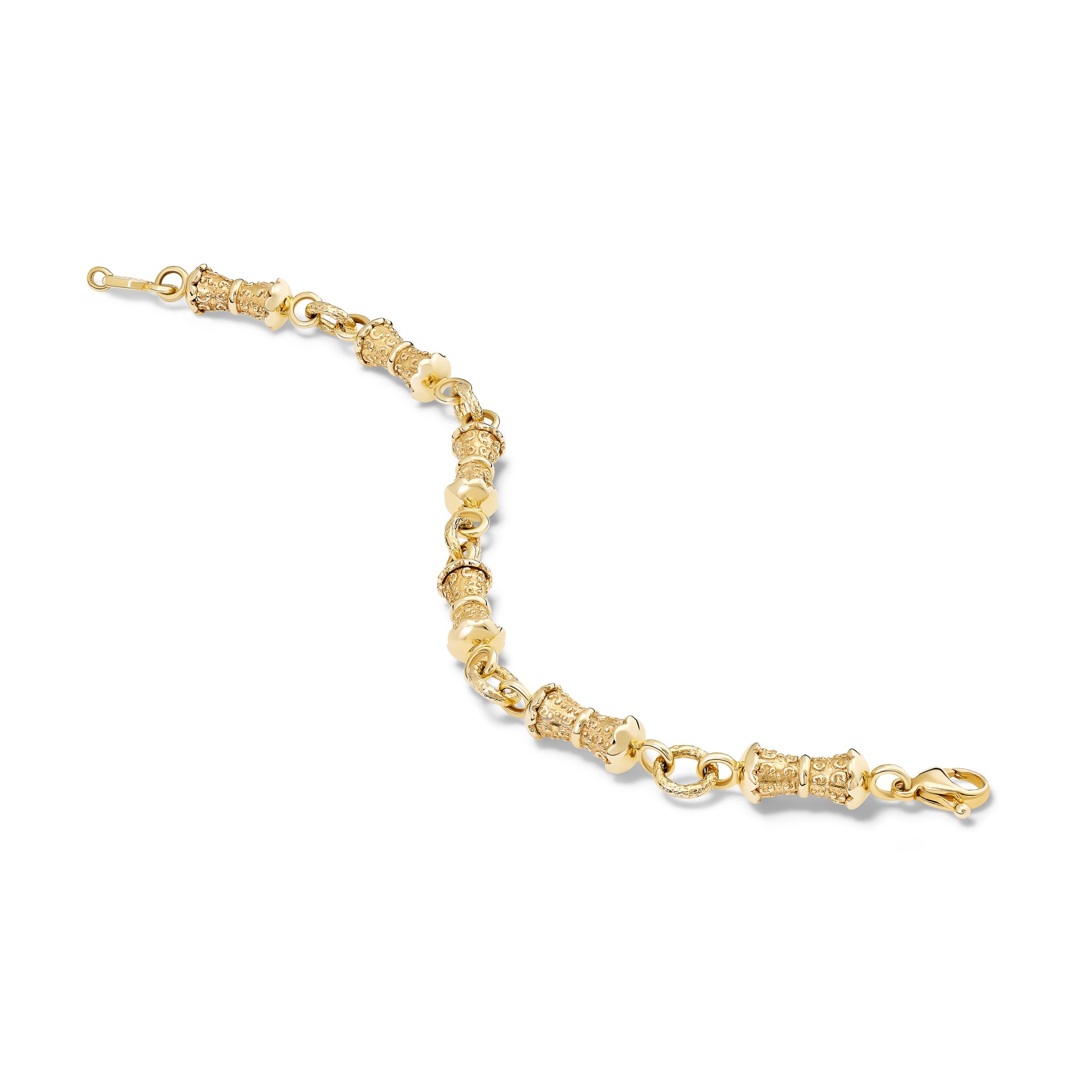 Handcrafted yellow gold bracelet featuring textured column shapes with links.
