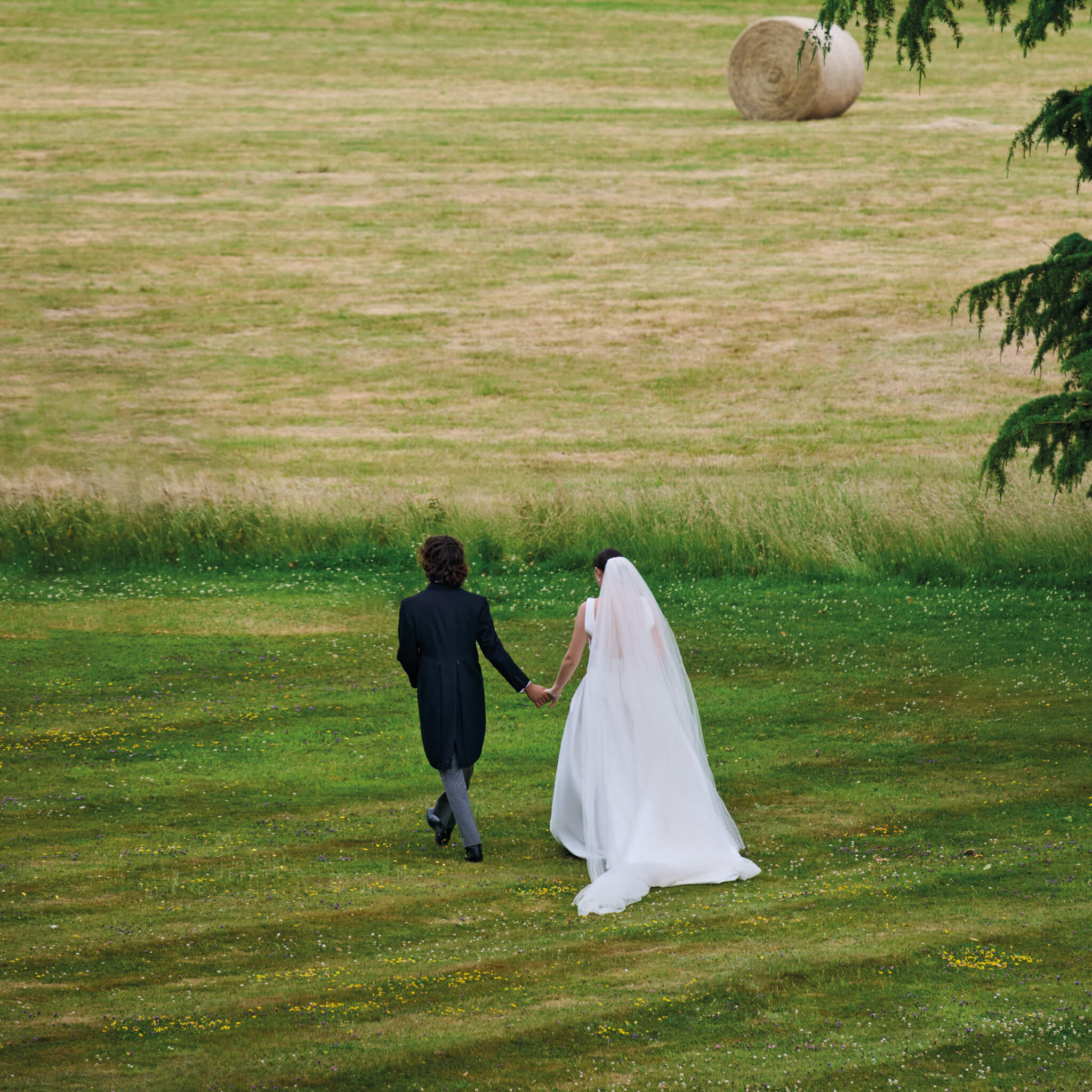 bride and groom on their wedding day wearing cassandra goad bridal jewels